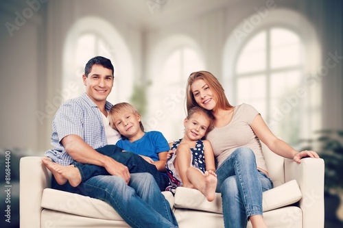 Positive young family with kid taking on cozy couch