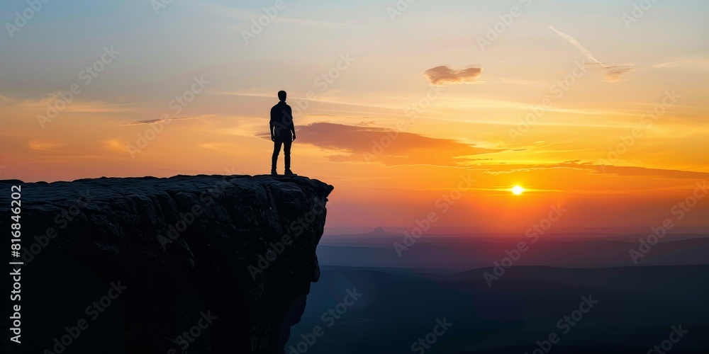 The man standing on the cliff watching the sunset. The man standing on the cliff watching the sunset.