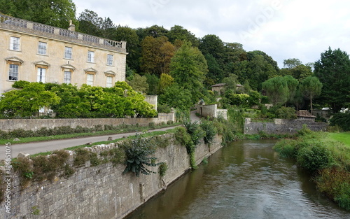 Scenic view of a river running through a village in the English countryside
