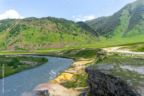 Yellow mineral salts on the banks of the Terek River in a valley among the mountains