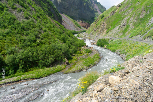 Stone and rocky banks of the Terek River at the bottom of the canyon among the mountains