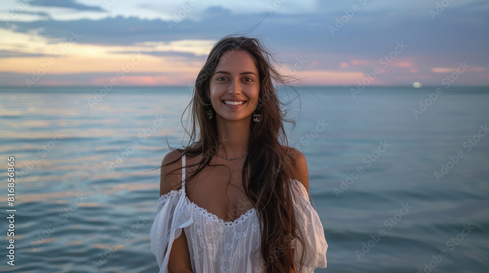 Beautiful indian lady in brown long hair and white dress, standing in front of the sea Beautiful indian lady in brown long hair and white dress, standing in front of the sea