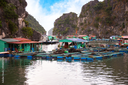 Floating fishing village in sea bay in Vietnam, boats and islands