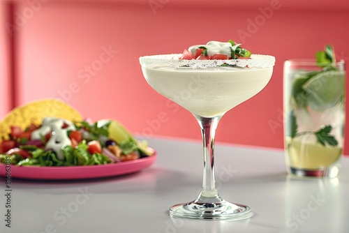 Fresh avocado cocktail garnished with cherry tomatoes in elegant glass