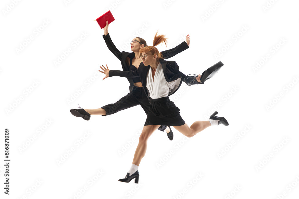 Fototapeta premium Multitasking and professional competition. Ambitions and motivated women in formal wear in dynamic pose running forward with documents isolated on white background. Concept of business, office life