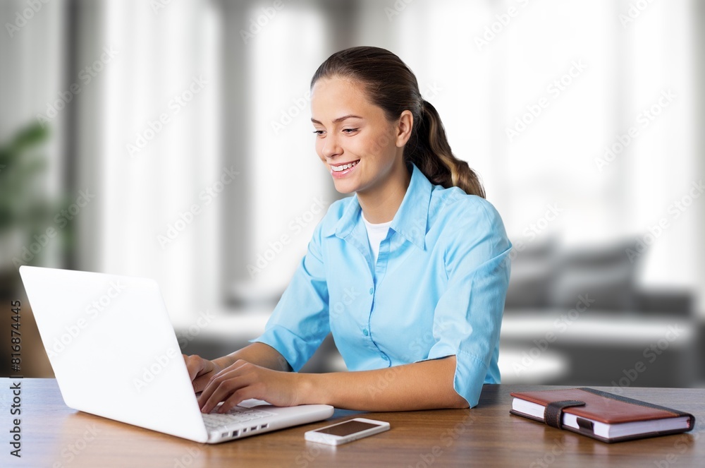 Young happy woman student looking at laptop Young happy woman student looking at laptop