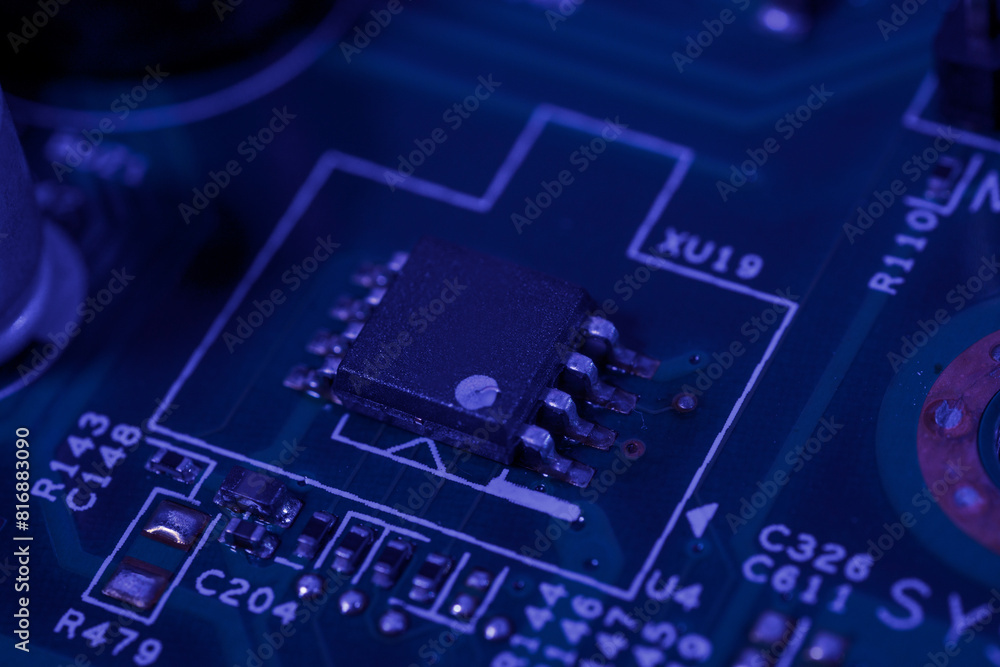 Fototapeta premium Close-up view of an integrated circuit mounted on a green printed circuit board.