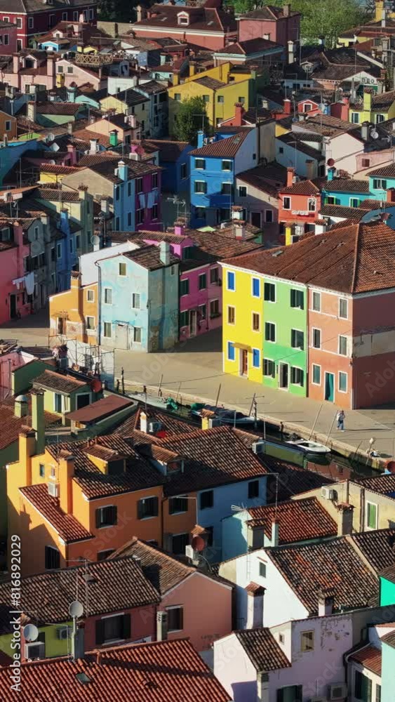 Aerial drone view of the colourful houses of Burano Island, Italy. Vertical Aerial drone view of the colourful houses of Burano Island, Italy. Vertical