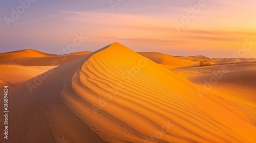 Desert sunset with golden dunes and blue sky