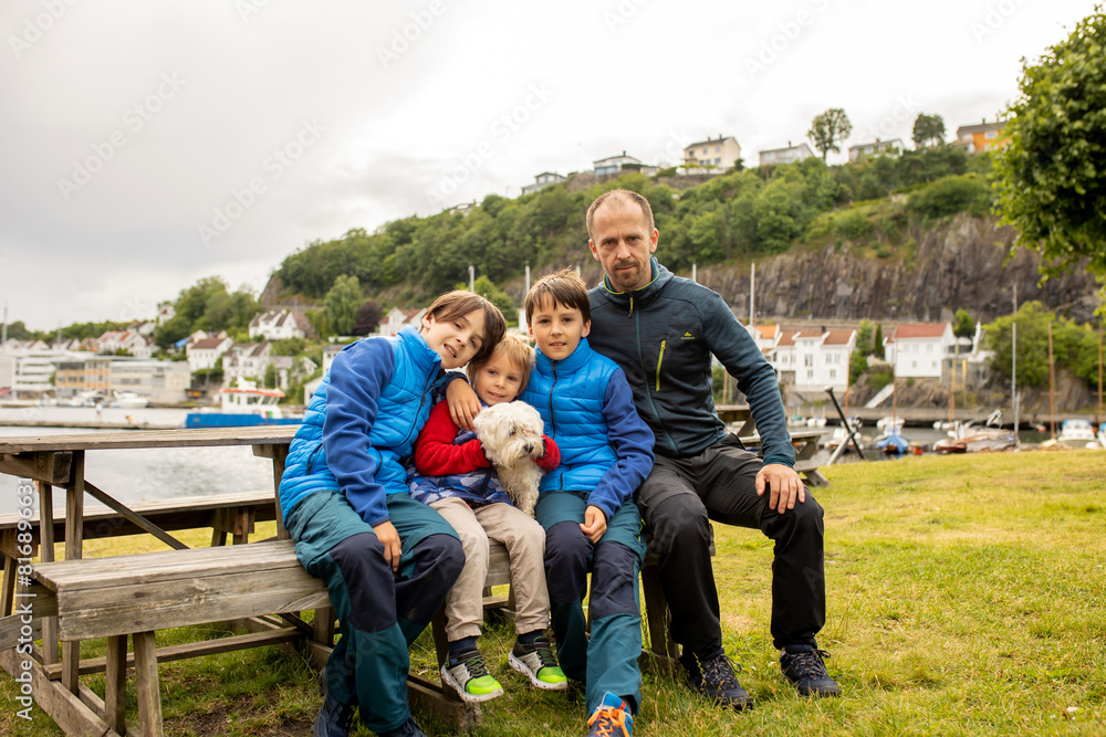 Child, visiting little town in south Norway, Arendal, on a rainy summer day Child, visiting little town in south Norway, Arendal, on a rainy summer day