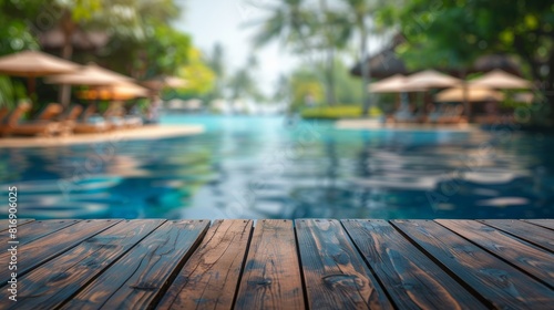 Image of wood table in front of swimming pool blur background. Brown wooden desk empty counter front view of the poolside on beautiful beach resort and outdoor spa.