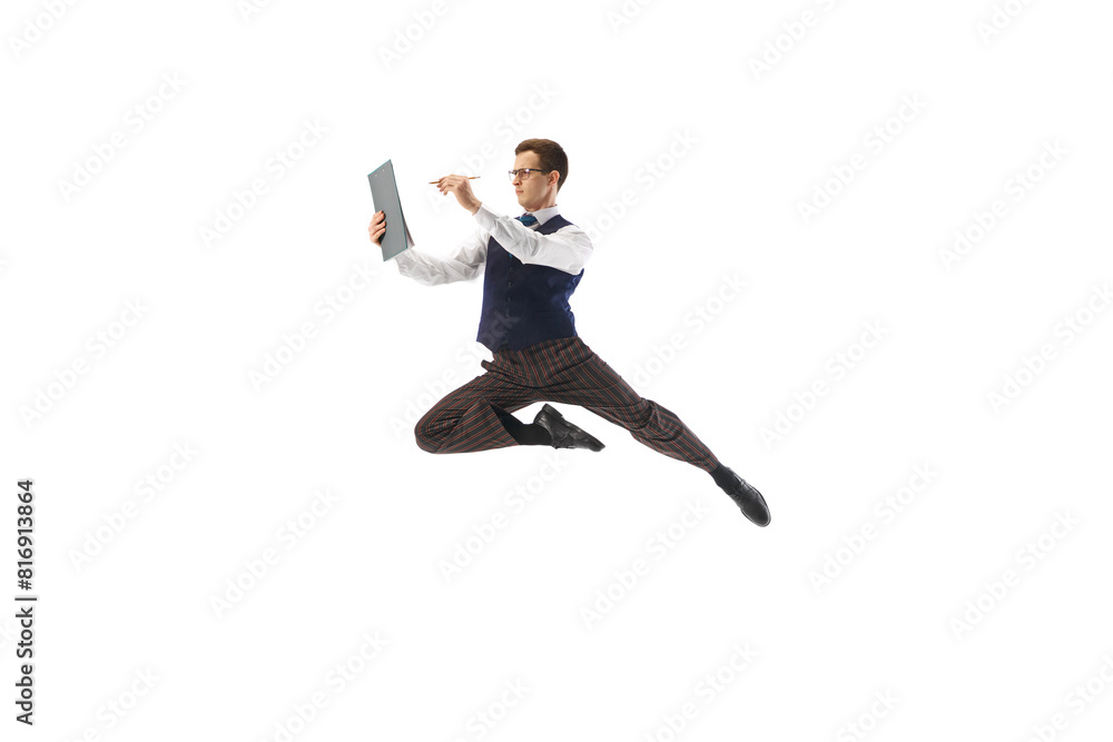 Focused and concentrated man, employee in formal wear, in mid-air pose looking on documents and working isolated on white background. Concept of business, office lifestyle, entrepreneurship