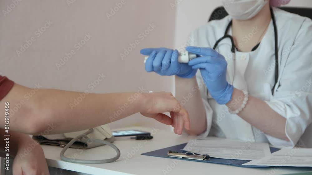The doctor applies the cream to the patient's hands The doctor applies the cream to the patient's hands