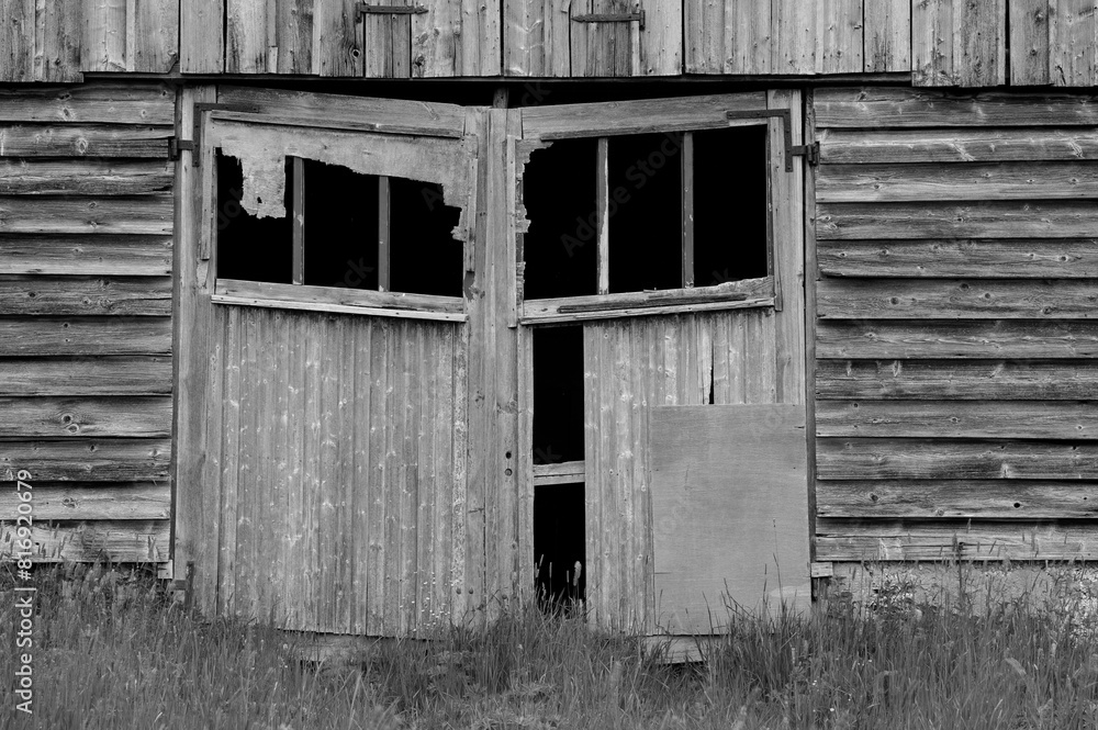 Lost in time, eerie monochrome of weathered barn door. Lost in time, eerie monochrome of weathered barn door.