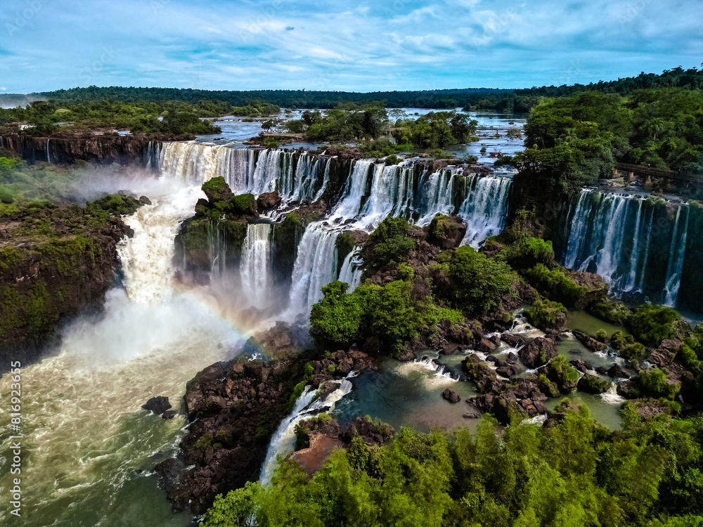Top down aerial view of the picturesque Iguazu (Iguacu) Falls on the border of Brazil and Argentina in a national park surrounded by tropical forest and trees. Drone shooting Top down aerial view of the picturesque Iguazu (Iguacu) Falls on the border of Brazil and Argentina in a national park surrounded by tropical forest and trees. Drone shooting