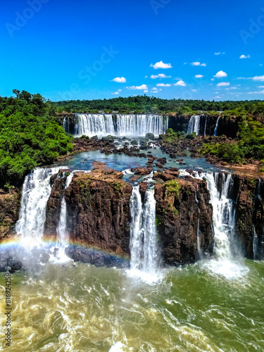 Top down aerial view of the picturesque Iguazu (Iguacu) Falls on the border of Brazil and Argentina in a national park surrounded by tropical forest and trees. Drone shooting