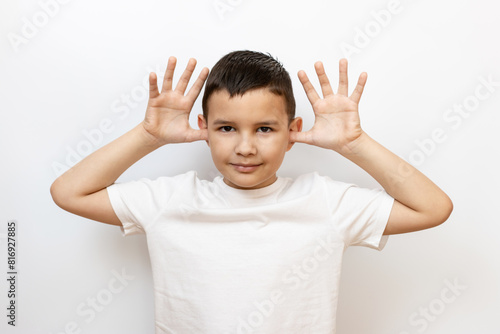 The guy raised his hands to his ears, shows a funny face. Sincere children's emotions.