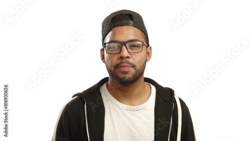 A young Afro-American man with glasses and a stylish black cap nods his head in an affirmative manner, expressing clear agreement and satisfaction, against a white background. Camera 8K RAW.  photo