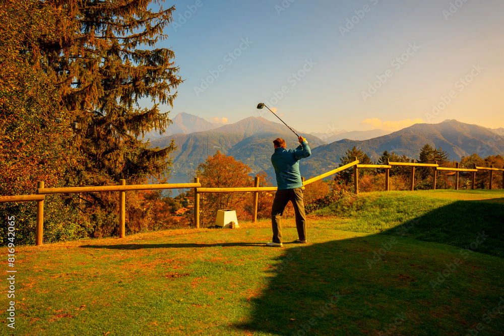 custom made wallpaper toronto digitalGolfer Teeing Off with His Driver on Golf Course Menaggio with Mountain View in Autumn in Lombardy, Italy.