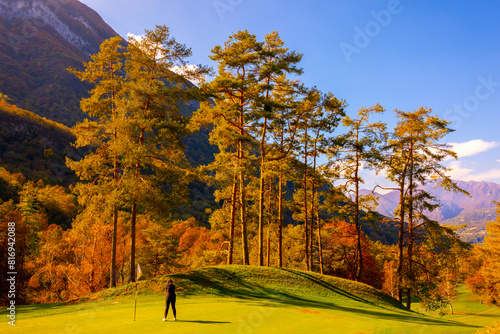 Golfer Putting on Putting Green on Golf Course Menaggio with Mountain View in Autumn in Lombardy, Italy.