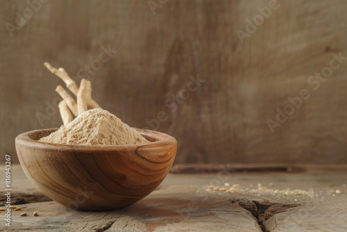 Wooden bowl filled with fine ashwagandha powder, a renowned superfood, displayed on a rustic table with a warm backdrop