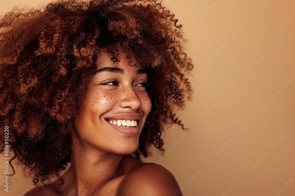 A woman with curly hair is smiling and looking at the camera A woman with curly hair is smiling and looking at the camera