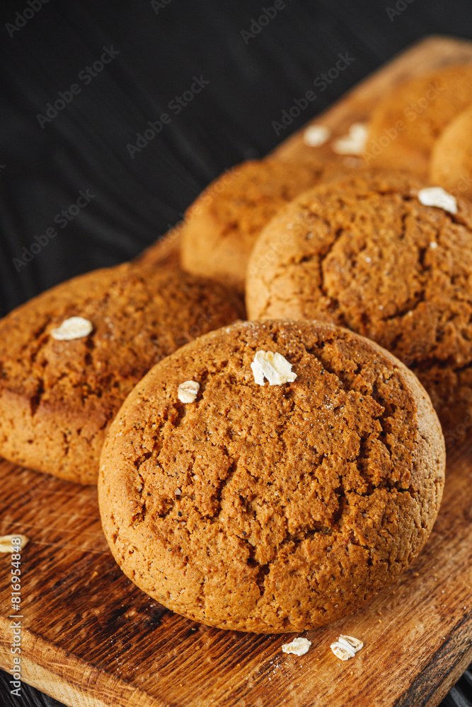 oatmeal cookies with a glass of milk on a black wooden rustic background oatmeal cookies with a glass of milk on a black wooden rustic background