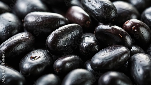 Macro shot of glossy black beans showing detailed texture and small size
