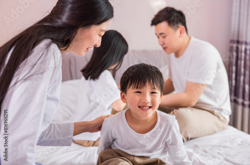 A family of four in bed in the bedroom