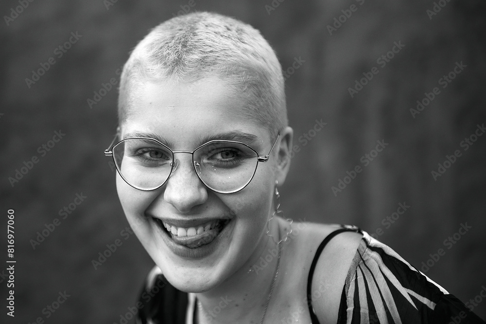 Beautiful girl with pink hair in a multi-colored dress and glasses. Emotions. Grain effect used Beautiful girl with pink hair in a multi-colored dress and glasses. Emotions. Grain effect used