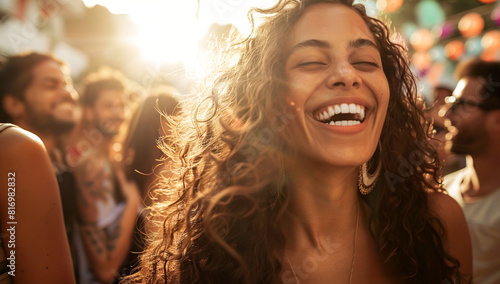 Young Latina woman joyfully smiling at an outdoor party photo