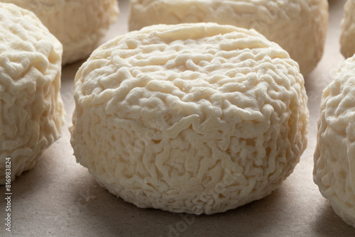 Group of wrinkled French Crottin de chevre, goat cheese, close up