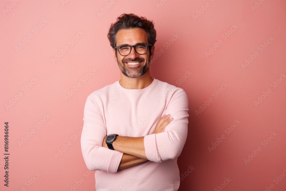 Portrait of a satisfied man in his 30s with arms crossed in pastel or soft colors background Portrait of a satisfied man in his 30s with arms crossed in pastel or soft colors background
