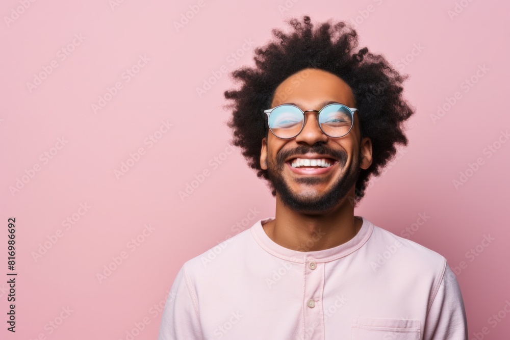 Fototapeta premium Portrait of a joyful afro-american man in his 30s smiling at the camera isolated in pastel or soft colors background