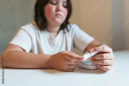 Young Girl Checking Blood Sugar Levels photo