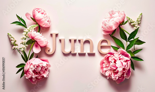 faction of word june with pink peonies on light background photo