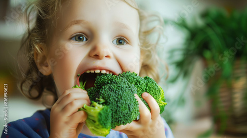Close-up of a young child happily eating fresh broccoli, showcasing healthy eating habits and enjoyment of nutritious vegetables.