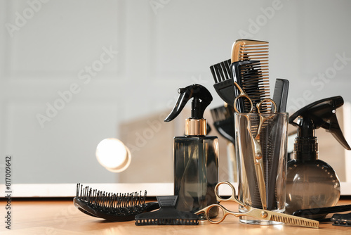 Foto Set of hairdresser tools on table in salon, space for text