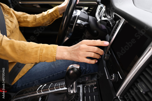 Woman using navigation system while driving her car, closeup