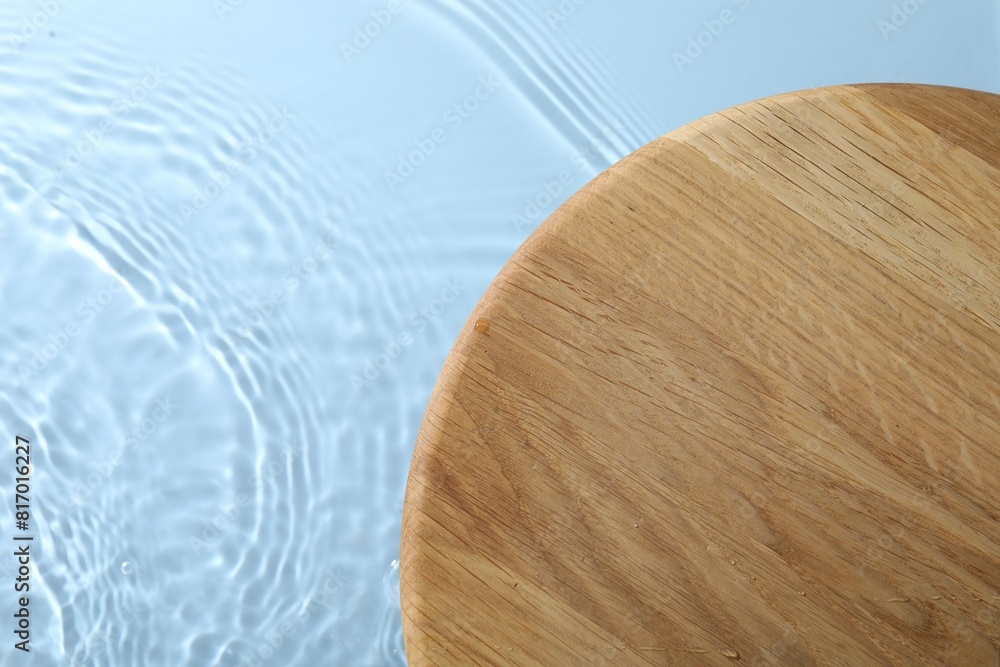 Wooden surface on light blue background, top view. Space for text Wooden surface on light blue background, top view. Space for text