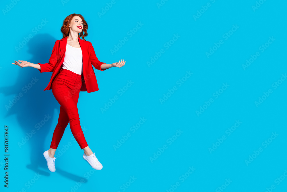 Photo of successful gorgeous nice girl wear red trendy clothes walk look empty space isolated on blue color background Photo of successful gorgeous nice girl wear red trendy clothes walk look empty space isolated on blue color background