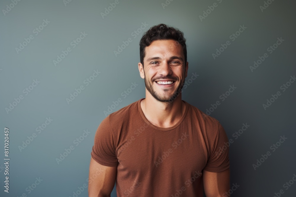 Portrait of a merry man in his 30s smiling at the camera on minimalist or empty room background Portrait of a merry man in his 30s smiling at the camera on minimalist or empty room background