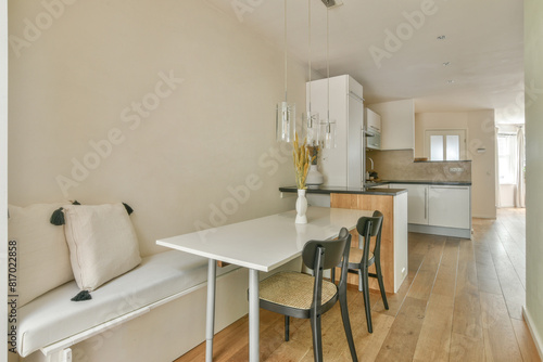 Modern kitchen and dining area in a bright apartment photo