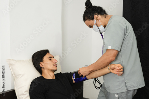 Nurse assisting man with hypoglycemia symptoms photo