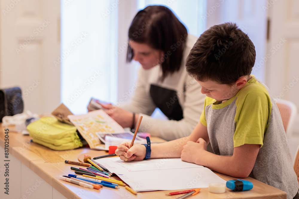 Siblings doing homework together at home Siblings doing homework together at home