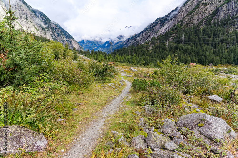 Scenic view of alpine landscape at hiking trail at Swiss mountain pass Grimsel on a cloudy late summer day. Photo taken September 19th, 2023, Grimsel, Canton Bern, Switzerland. Scenic view of alpine landscape at hiking trail at Swiss mountain pass Grimsel on a cloudy late summer day. Photo taken September 19th, 2023, Grimsel, Canton Bern, Switzerland.
