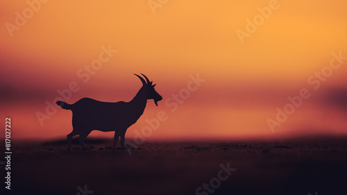 Canvas Print silhouette of a goat against a sunset sky background with copy space for the Eid Adha celebration concept, in a silhouette style