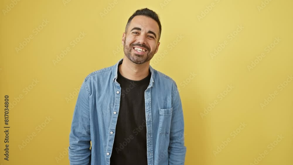 Fun, young hispanic man in denim shirt, making crazy fish-face gesture. comical expression over yellow isolated background! Fun, young hispanic man in denim shirt, making crazy fish-face gesture. comical expression over yellow isolated background!