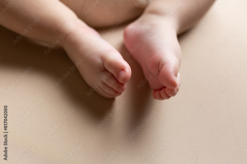 a small child lies on a light background. newborn boy. baby's first photo shoot a small child lies on a light background. newborn boy. baby's first photo shoot