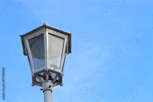 Street lamp in Yogyakarta with blue sky background. Old style metal electricity lamp